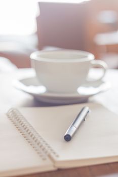 Blank notebook with pen on wooden table, stock photo