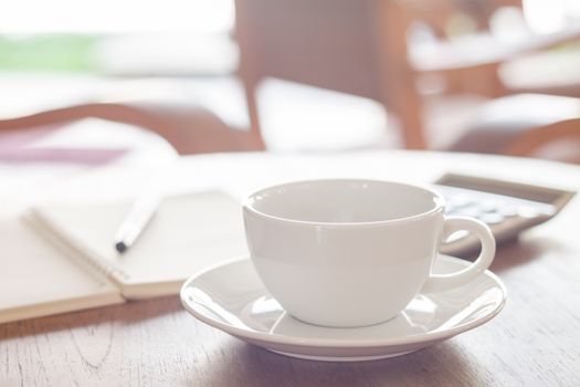 White coffee cup on wooden table, stock photo