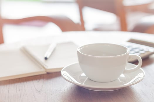 White coffee cup on wooden table, stock photo