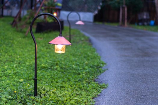 Beautiful garden walkway lighting with lamps at night