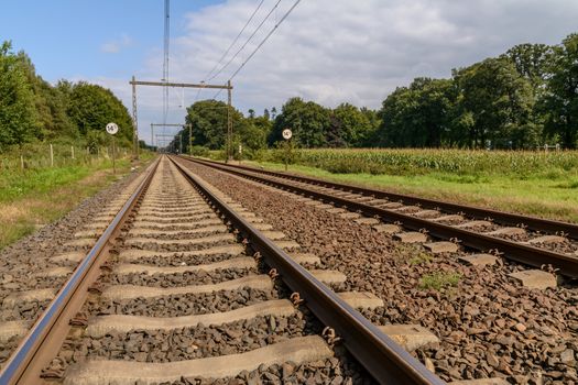 Rusty railway tracks on sunny day in Holland