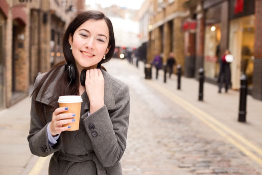 young woman with a coffee and headphones