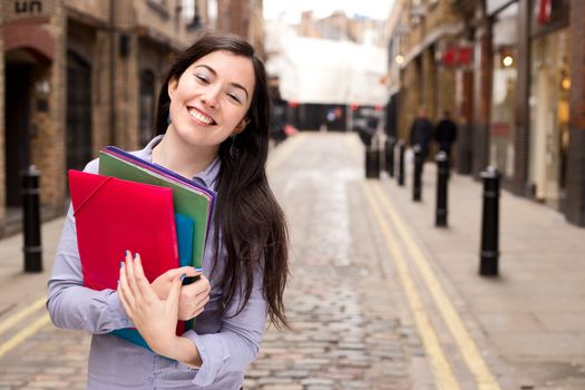 young woman holding folders