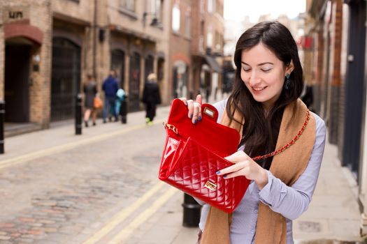 girl holding her handbag