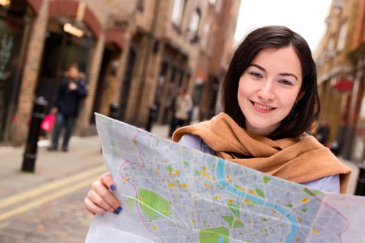 young woman holding a map.