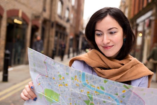 young woman reading map