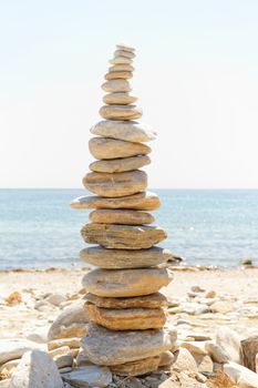 Photo of a tall stone sculpture in the beach 