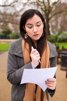 young woman reading a form