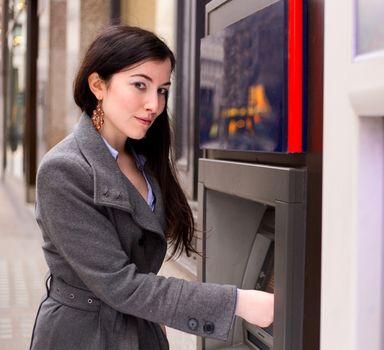 young woman at the cash machine