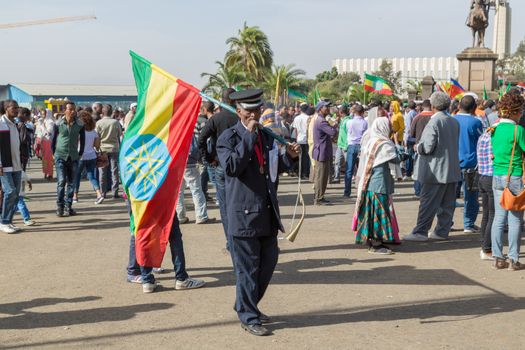 Addis Ababa - Sept 2: A war veteran carries a large Ethiopian flag in front of Emperor Menelik's Monument during the celebrations of the 119th Anniversary of the Ethiopian Army's victory over the invading Italian forces in the 1896 battle of Adwa. September 2, 2015, Addis Ababa, Ethiopia.
