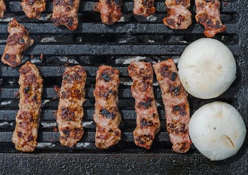 Cevapcici - Minced Meat Rolls and Champignons - White Mushrooms - on a grill 