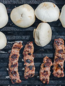 Cevapcici - Minced Meat Rolls and Champignons - White Mushrooms - on a grill 