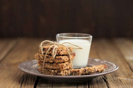 Granola bars with glass of milk on wooden background horizontal