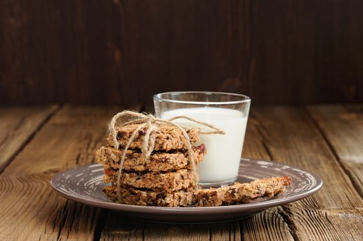 Granola bars with glass of milk on wooden background horizontal