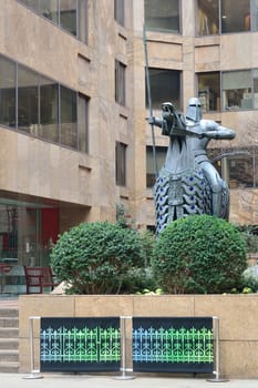 Modern statue of knight by new building