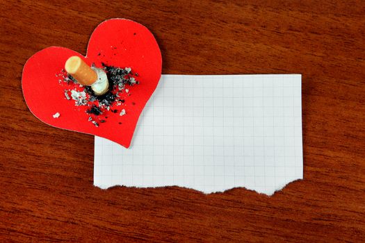 Cigarette in Heart Shape and Empty Paper on the Table