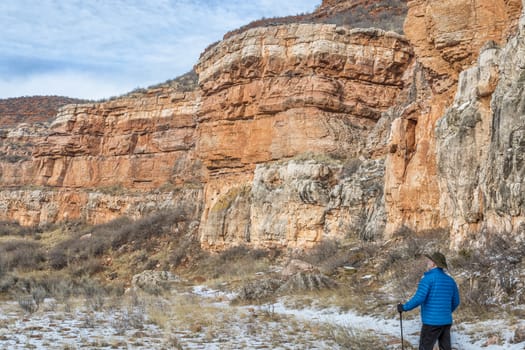 senior male hiking in sandstone canyon in winter, Red Mountain Open Space near Fort Collins, Colorado