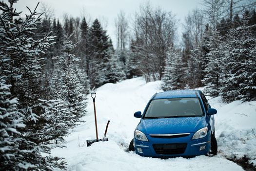 Car Stuck in the Snow on a Forest Road in the Middle of Nowhere.