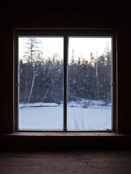 Calm Scene of Nature during Winter through the Window Pane of a Shack on a Cold Morning