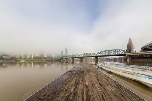 Floating Boat Dock on Willamette River with Portland Oregon Skyline and Hawthorne Bridge on Foggy Morning