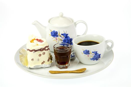 cup of coffee and delicious cake on white background