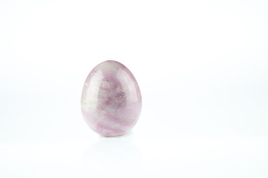 Rose Quartz egg shaped massage gemstone on white background