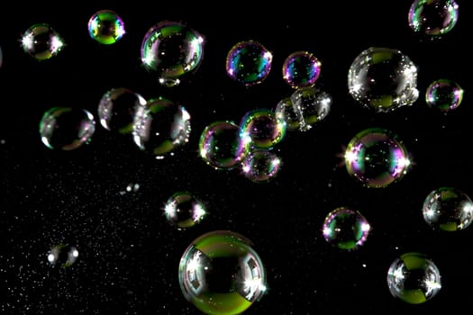 Soap bubbles with light  on black blackground