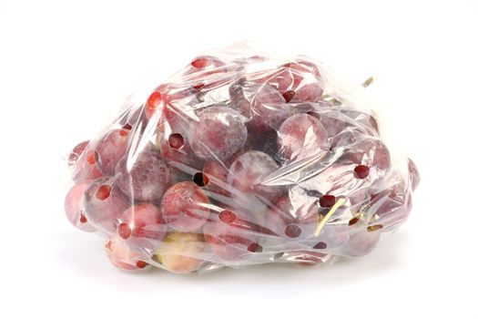 Close up red grape were plastic bags ready for sale on white background