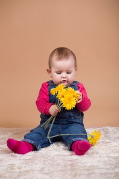 infant baby with yellow flowers - the first year of the new life