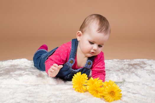 infant baby with yellow flowers - the first year of the new life
