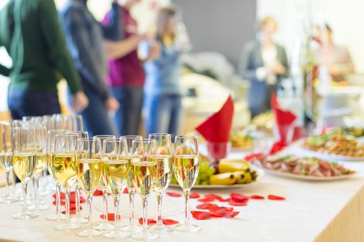 Banquet event. Table with the wineglasses, snacks and cocktails.