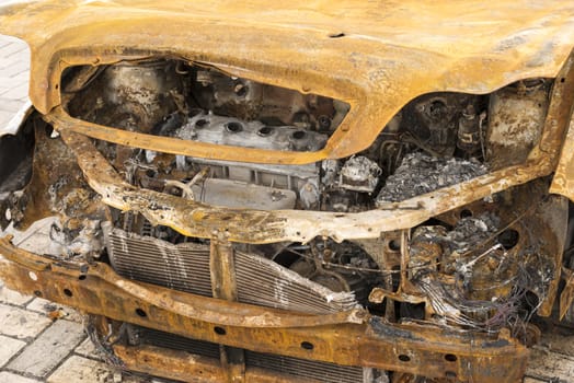 front of burnt out abandoned car