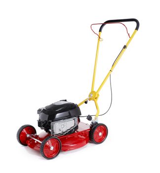 New red retro styled lawn mower isolated on white with natural shadows.