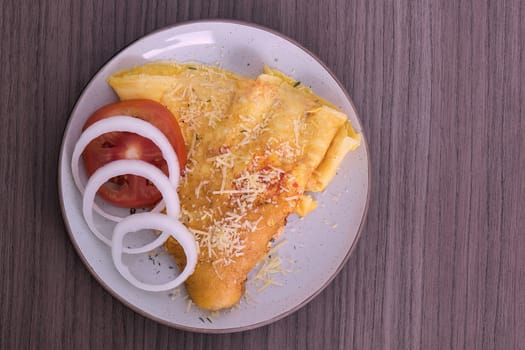 Overhead view of a dish of omelette with parmesan cheese