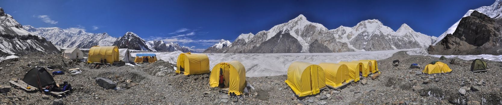 Scenic panorama of tents on Engilchek glacier in picturesque Tian Shan mountain range in Kyrgyzstan