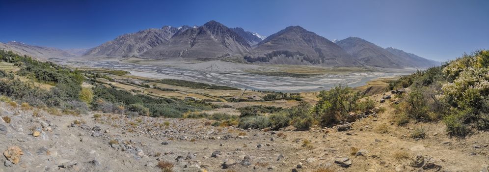 Scenic panorama of valley on arid landscape in Tajikistan on sunny day