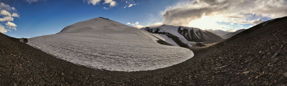 Scenic panorama of cold arid landscape in Tajikistan by sunset