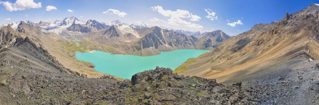 Scenic panorama of picturesque turquoise lake in Tien-Shan mountains in Kyrgyzstan
