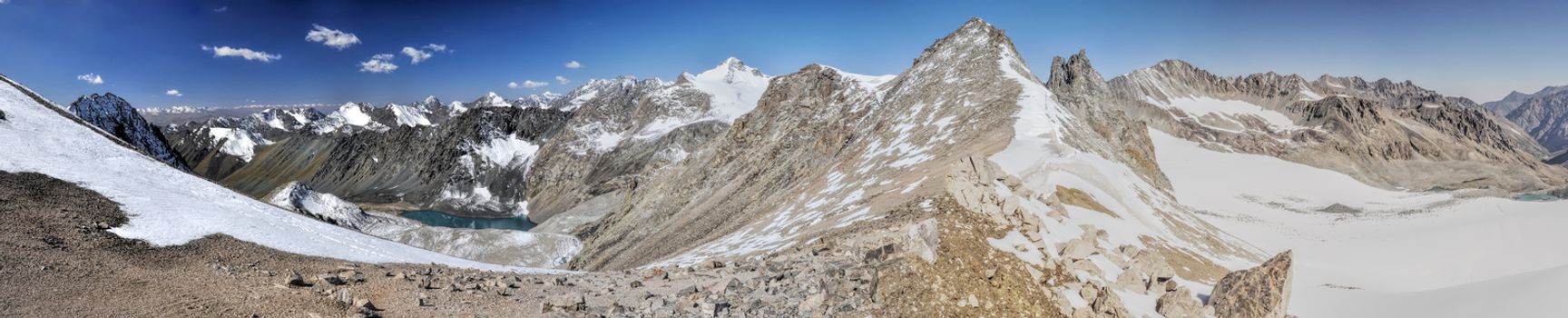 Scenic panorama of lake below highest mountain peaks in Ala Archa national park in Tian Shan mountain range in Kyrgyzstan