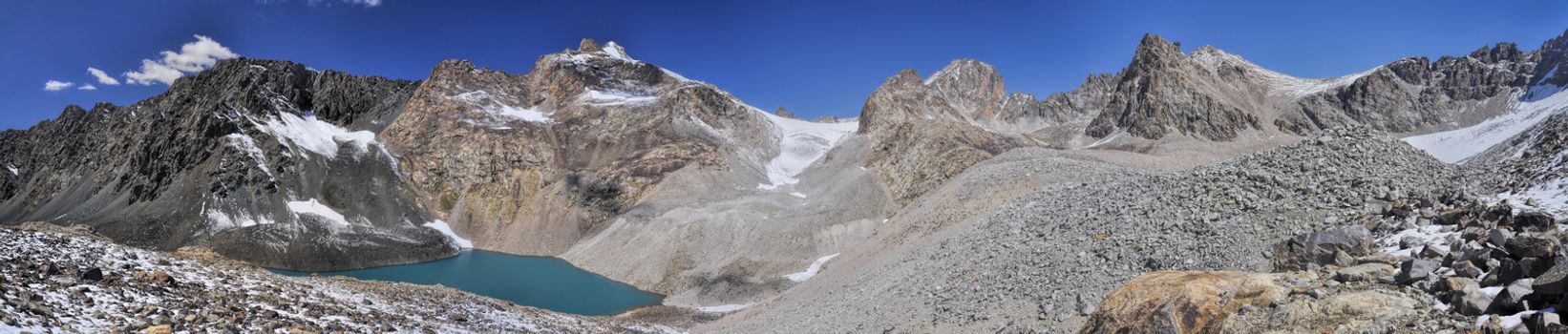 Scenic panorama of lake below highest mountain peaks in Ala Archa national park in Tian Shan mountain range in Kyrgyzstan