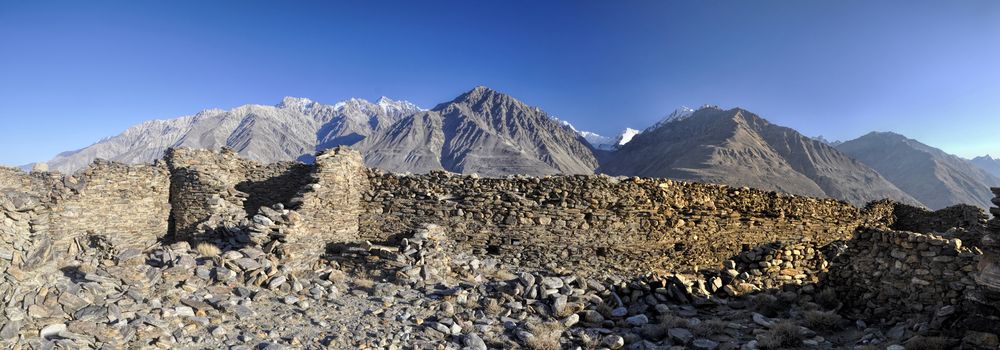 Scenic panorama of old ruins on arid landscape in Tajikistan on sunny day