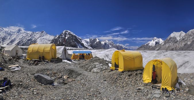 Scenic panorama of tents on Engilchek glacier in picturesque Tian Shan mountain range in Kyrgyzstan