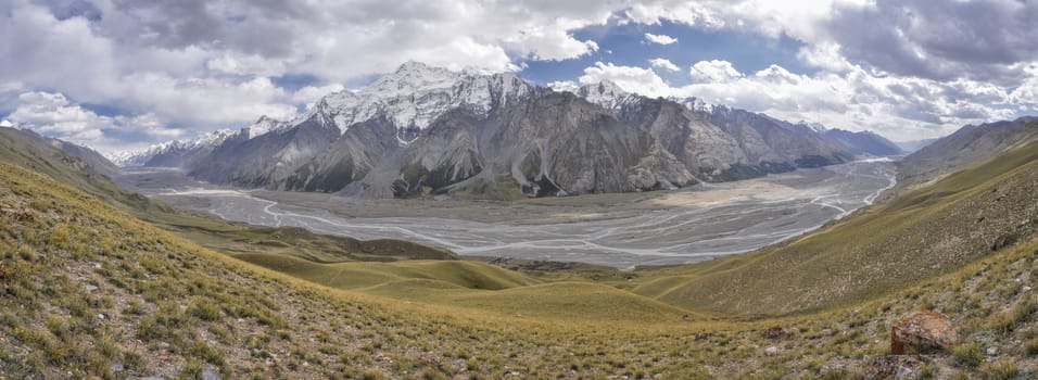 Scenic panorama of valley and mountain peaks in Tien-Shan mountain range in Kyrgyzstan
