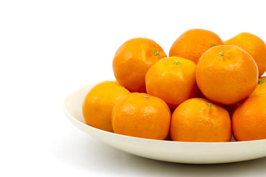 tangerines in a bowl on white background