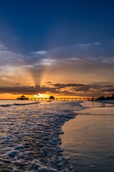 The beautiful sun setting on the shores of Fort Myers Beach located on Estero Island in Florida, United States of America