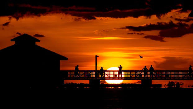 People watching the beautiful sunset on the shores of Fort Myers Beach located on Estero Island in Florida, United States of America