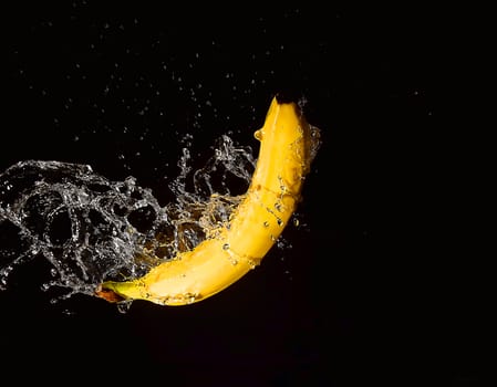 yelow banana in drops of water