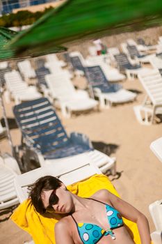 Sexy young woman sunbathing on the beach