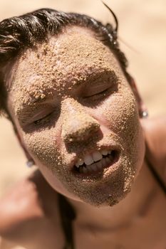 Beautiful girl portrait with sand on face