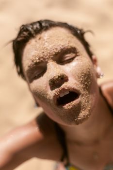 Beautiful girl portrait with sand on face